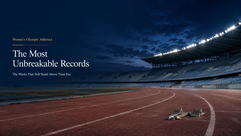 Empty athletics stadium at night with running track and starting blocks for an article on unbreakable women’s Olympic athletics records.