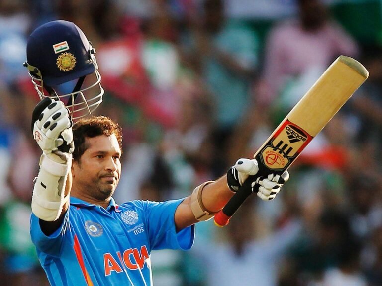 Sachin Tendulkar celebrating with bat and helmet showing cricket records that may never be broken